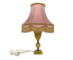 a lamp with a pink shade on it and a cord plugged into the light