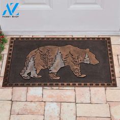 a door mat with a bear and pine trees on the front entrancemat, next to a white door