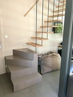 there is a set of stairs leading up to the second floor in this modern home