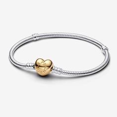 Give your charms a romantic backdrop with this Pandora Moments Heart Clasp Snake Chain Bracelet, a new rendition of our classic charm bracelet. Cast in sterling silver, the signature snake chain design is updated with a 14k gold-plated unique metal blend heart-shaped clasp. The clasp is stamped with the Pandora logo. Available in-store and online. | Pandora Moments Heart Clasp Snake Chain Bracelet in Sterling silver/14k Gold-plated unique metal blend in Various Sizes Pandora Chain Bracelet, Pandora Logo, Dangle Bracelet, Romantic Backdrop, Charms Pandora, House Logo, Bracelet Pandora, Silver Plated Bracelet, Snake Chain Bracelets