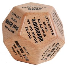 a wooden dice with words on it