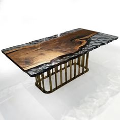 a table made out of wood and metal with an abstract design on the top, sitting on a white background