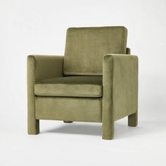 a green chair sitting on top of a white floor