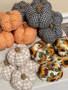 pumpkins and sunflowers are sitting on the counter