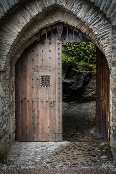 an old stone building with a wooden door