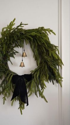 a wreath with bells hanging on the wall