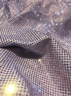 a close up view of shiny fabric with lots of sequins on the surface