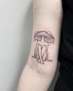 a couple under a mushroom tattoo on the arm