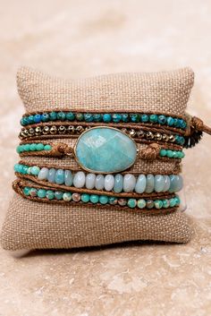 Long, thin brown vegan leather strand that wraps around wrist multipletimes. In addition, a large aqua stone charm with naturalstones/beads and silver sunflower closure. Aqua Stone, Brown Leather Strap, Hello Gorgeous, Stone Bracelet, Stone Beads, Wrap Bracelet, Natural Stones, Leather Bracelet, Leather Straps