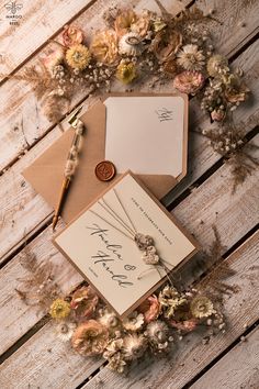 wedding stationery with flowers on wooden table