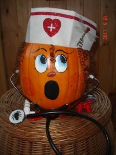 a pumpkin with a stethoscope on top of it sitting in a basket