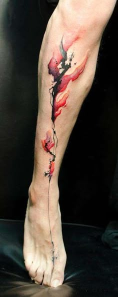 a woman's leg with a flower tattoo on it