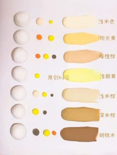 an assortment of different shades of paint on a white surface with chinese characters in the background