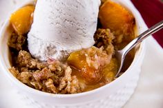 a white bowl filled with fruit and ice cream