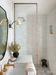 an instagram photo of a white bathroom with gold accents