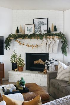 a living room decorated for christmas with stockings on the mantel and stockings hanging over the fireplace