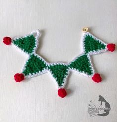 a crocheted christmas tree ornament hanging on a wall