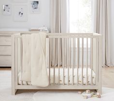 a white crib in a neutral nursery