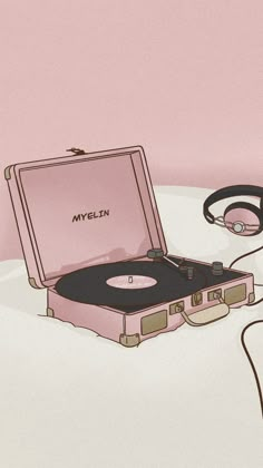 an old record player with headphones on top of it and a pink suitcase next to it