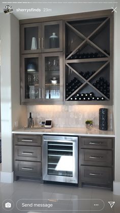 a kitchen with stainless steel appliances and wine bottles on the wall above it is also built in cabinets