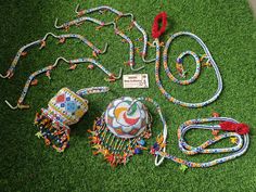 a group of colorful items laying on top of a green grass covered field next to each other