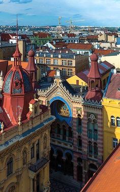 an aerial view of the city with many buildings and colorful architecture on it's sides