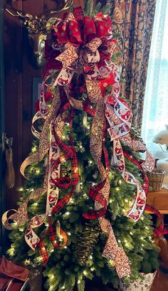 a christmas tree decorated with bows and ribbons