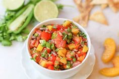 a white bowl filled with salsa next to chips