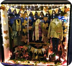 a window display with clothes and lights in it