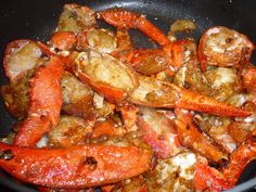 cooked lobsters and potatoes in a wok