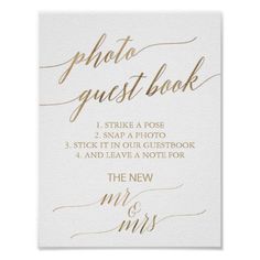 a white and gold wedding guest book with calligraphy on the front, in gold foil