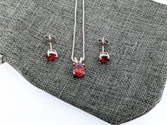 Garnet Necklace and Earring Set. Silver Garnet Pendant. Silver Garnet Studs. Garnet Jewelry Set. Silver Garnet Necklace Set. 925 January Birthstone Chain Length Of 14-20 Available Face Height: 7mm Pendant 6mm Studs Metal Material: Sterling Silver, Synthetic Emerald