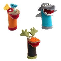 three stuffed animals are in the shape of toothbrushes with mouths and teeth on them