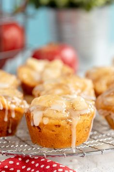 muffins with icing sitting on a cooling rack