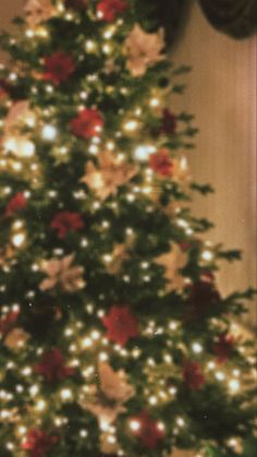 a decorated christmas tree with red and white flowers