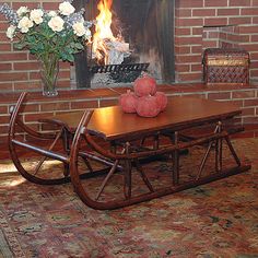 a living room with a fire place and a coffee table in front of the fireplace