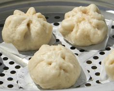 some dumplings are sitting in a metal pan