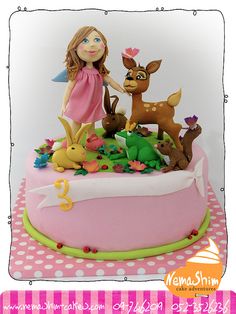 a birthday cake with a girl and deer on it