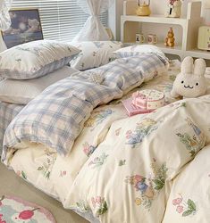 an unmade bed in a bedroom with pillows and blankets on top of the bed