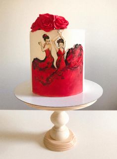 a red and white cake with two women on it