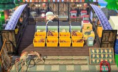 an animal farm with lots of animals in the yard and some crates on the ground