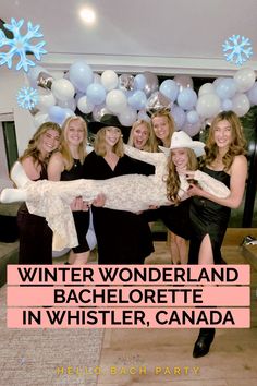 a group of women standing next to each other in front of balloons and snowflakes