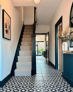 an entry way with stairs and tiled flooring