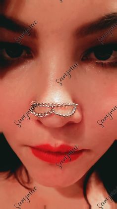 a woman with chains on her nose wearing a chain around her nose and nose ring