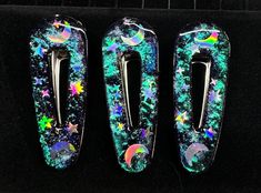 A set of 3 Celestial Barretes with Holographic moons and stars set on a Color changing mica pigment background.  The colors morph from Green to blue to purple. Resin Barrettes, Moons And Stars, Green To Blue, Holographic Glitter, A Color, Gift Accessories, Barrettes, Violet, Hair Accessories