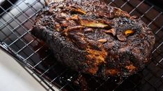 a large piece of meat sitting on top of a grill