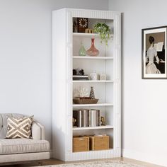 a living room with a couch and bookcase in the corner next to a painting on the wall