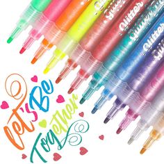 several different colored pens are lined up in the shape of hearts and words that spell out love