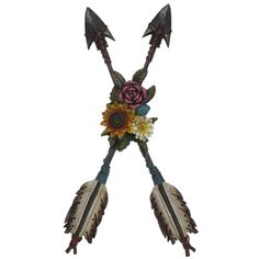 an arrow with flowers and feathers attached to it