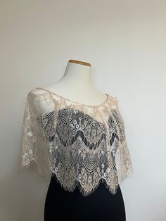 "Lace wedding dress topper. Bridal capelet.  Fancy Lace wedding cape.  Shoulder cover-up stole.  Bridal Lace bolero.  Bridal capelet.  Off-shoulder stole. Special occasion shawl.  Bridal bolero.  Available in two colors ( Black or Cream)  Black Lace has an adjustable chiffon ribbon tie.  Cream lace has a pearl beaded ribbon around the shoulder  Length : 11\"  Shoulder perimeter: 33\"" Fitted Capelet With Cape Sleeves For Wedding, Elegant Party Capelet, Elegant Shawl Capelet For Weddings, Elegant Wedding Capelet Shawl, Elegant Wedding Shawl Capelet, Elegant Capelet For Party, Elegant Fitted Capelet, Elegant Fitted Capelet For Evening, Fitted Elegant Shawl With Lace Trim